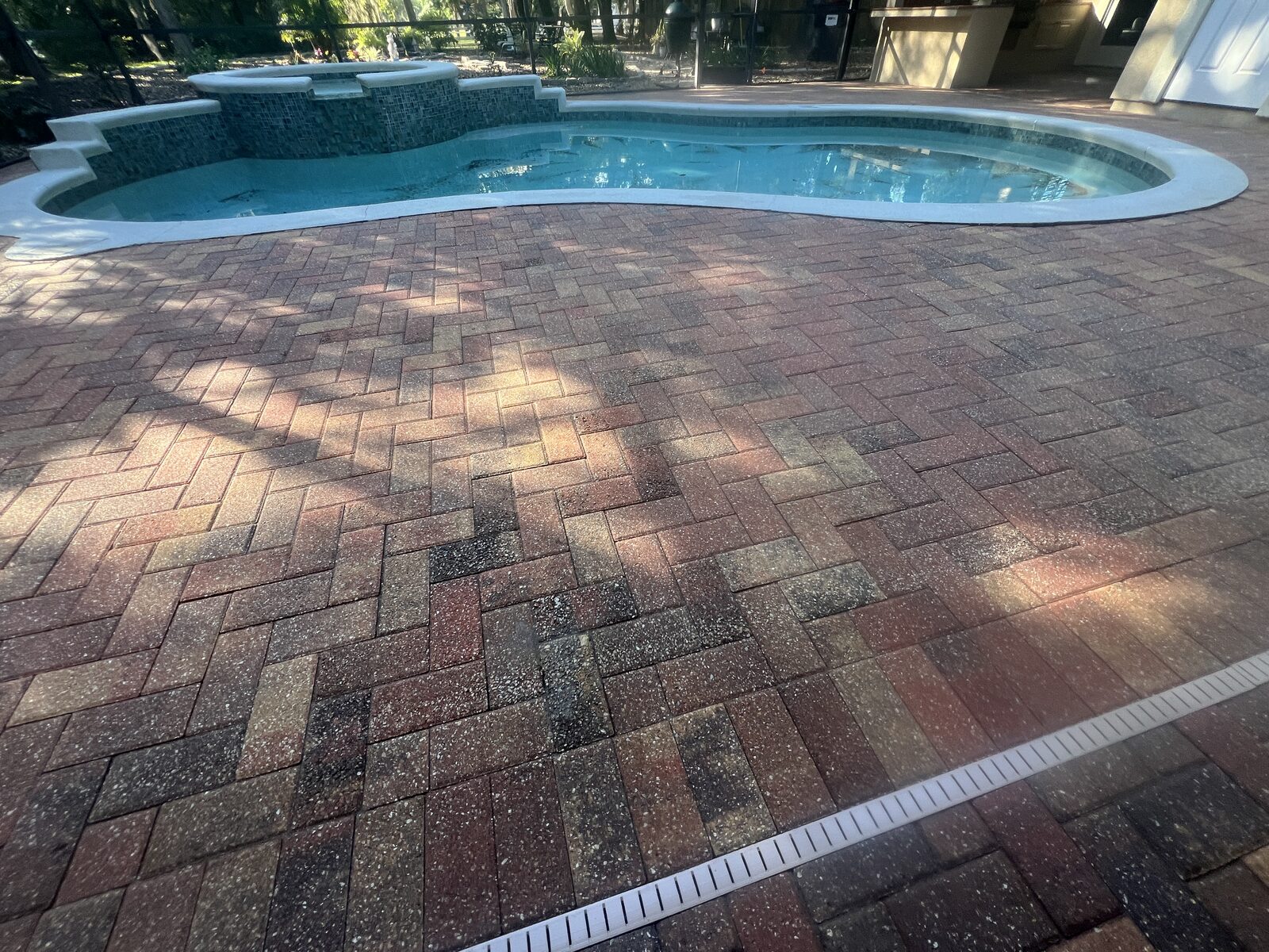 Soft washing an asphalt shingle roof to remove algae and stains